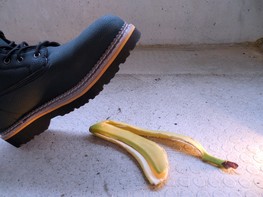 A photo of a shoe about to step on a banana peel