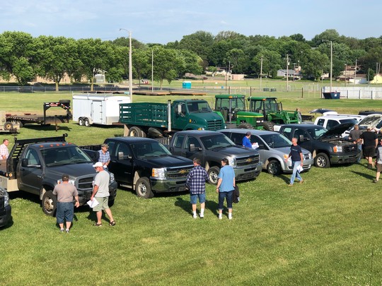 People looking at trucks at the DNR auction