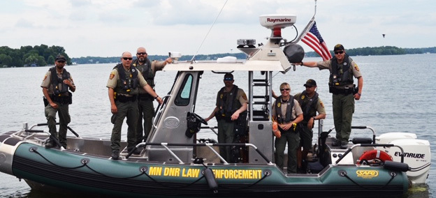 Conservation officers and other safety officials on patrol boat