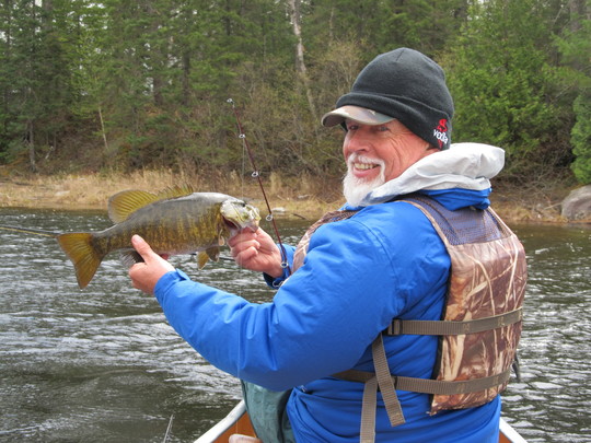 Rick Barta on the water, holding a fish