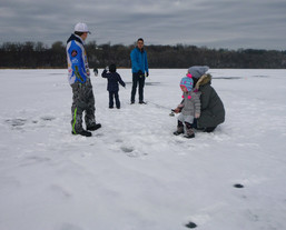a group of kids and adults fishing