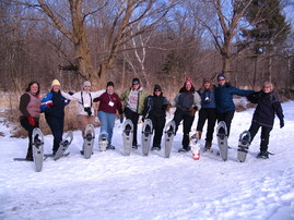 group of women snowshoeing and posing for a photo