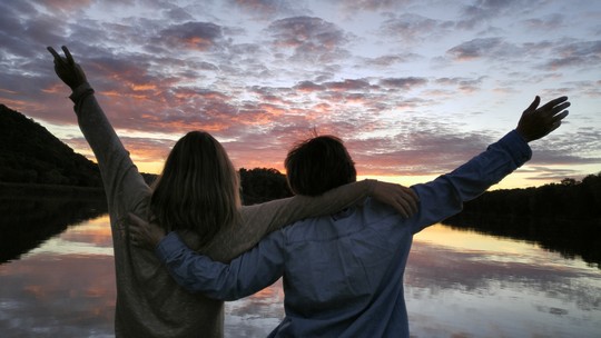 two people celebrating sunset