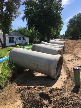 Stormsewer pipes on road in preparation for installation