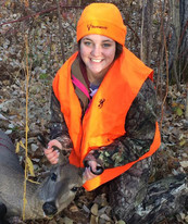 youth wearing blaze orange and camo with harvested deer