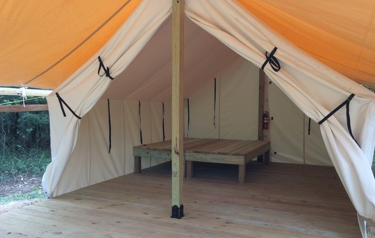 Image of walled tent with woods in background