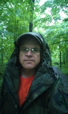 Man in the woods on a rainy day