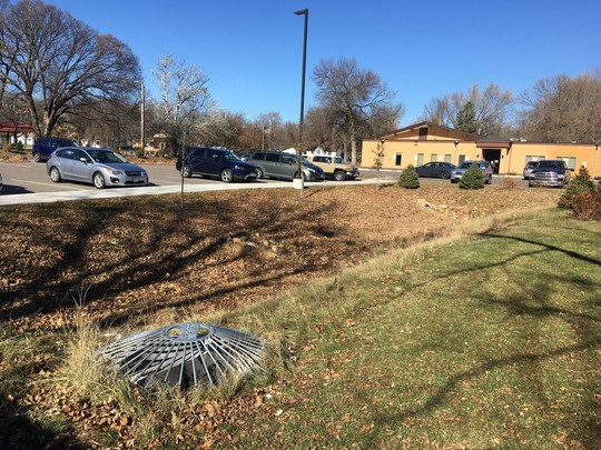 Stormwater retention area next to parking lot and church