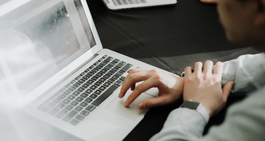 A stock image of a man at a computer