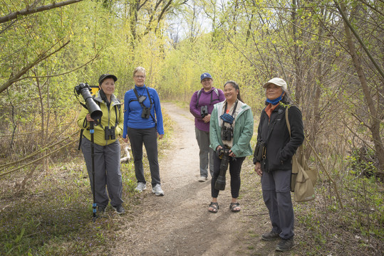 Group shot of people standing on trail in the woods