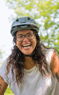 Woman with bike helmet and a big smile