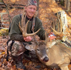 archer with large buck he harvested at Camp Ripley hunt