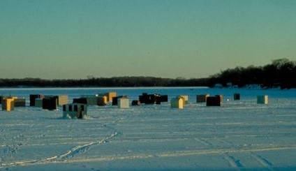 Ice houses on frozen lake