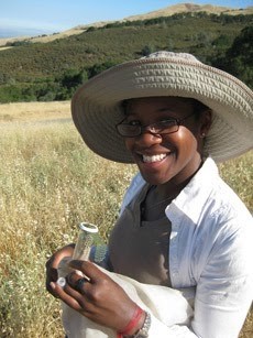 Dr. Alex Harmon-Threatt photo of herself in a prairie surveying pollinators
