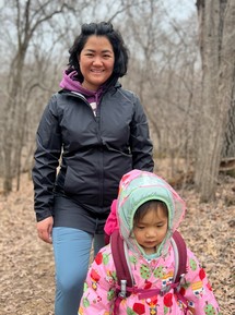 Karen woman with her young daughter enjoying a Spring day in the park.