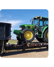 Photo of tractor on trailer bed