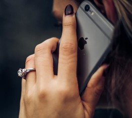 A woman holding a phone to her ear