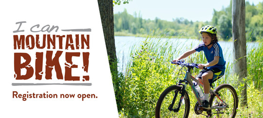 Young Asian-American boy mountain biking through a forest by the lake. Text reads "I Can Mountain Bike! Registration is now open."