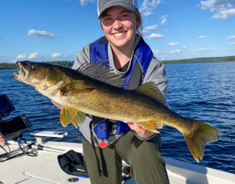 angler holding large walleye she caught on Lake Vermilion