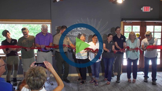 A screenshot from the video with a "play" icon over it