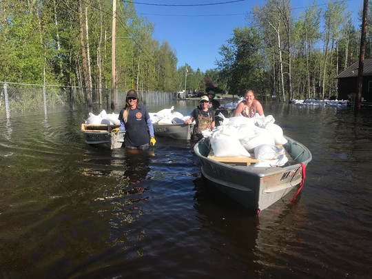 Flooded road and transporting sandbags in Ranier, MN
