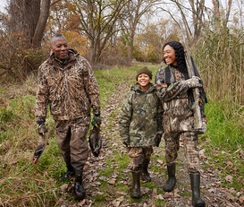 family duck hunting with man, woman, kid