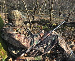 a turkey hunter with decoys in the distance