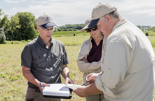 A photo of Andrew Graham with colleagues in the field at the Goose Prairie WMA