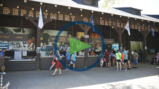 A screenshot from a video about the State Fair with a "play" icon over it