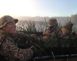 youth out waterfowl hunting, looking into the marsh on a foggy morning