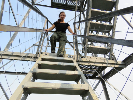 Woman walking down the fire tower stairs.
