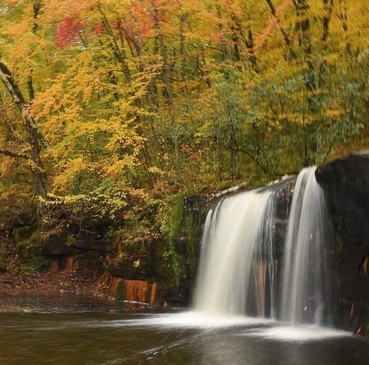 Banning State Park waterfall with fall colors in background