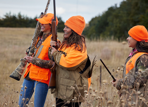 three pheasant hunters smiling