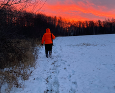 hunter walking out on a snowy morning at sunrise