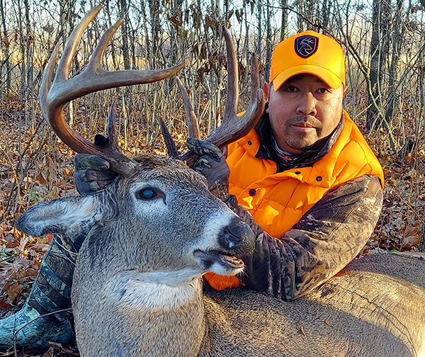 hunter with a buck he harvested