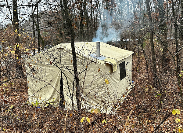 fancy camp shelter with a fireplace