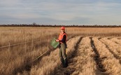 Dr. Anna Peschel stands in a sampling grid for the healthy prairies project.