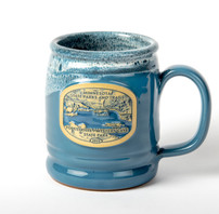 A teal ceramic mug with an image representing the 2023 Minnesota state park vehicle permit.