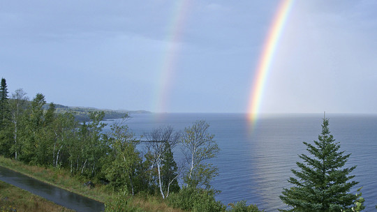 Gitchi Gami State Trail with rainbow over Lake Superior.