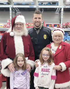 Mitch Lawler with Santa, Mrs. Claus and two kids