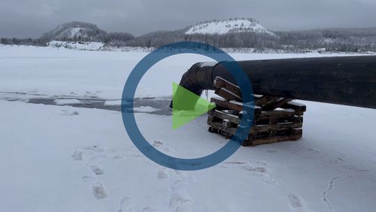 A screenshot of a video with a play icon superimposed on it