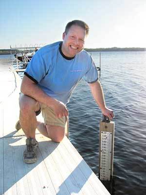 Reading a lake level gage on dock