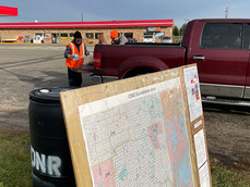 NW area permit area map at in-person sampling station with truck and sampling in background