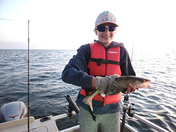 an angler on Mille Lacs Lake with a walleye