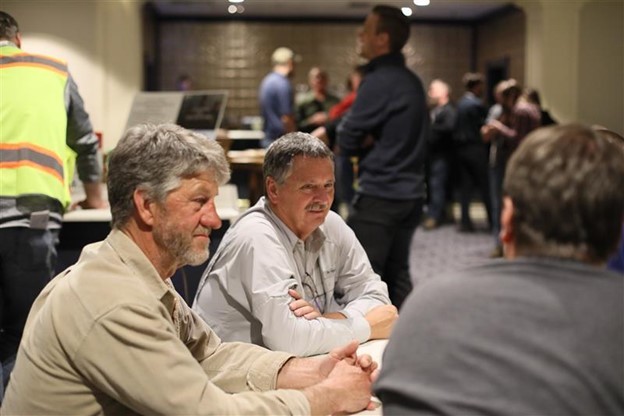 Kevin Stauffer (center) discusses the Mississippi River with other UMRCC participants at the 78th Annual Meeting in Red Wing