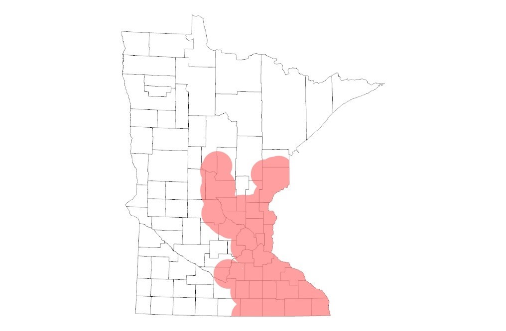 A map of Minnesota, with the southeastern part of the state shaded in red showing the known range of oak wilt in the state