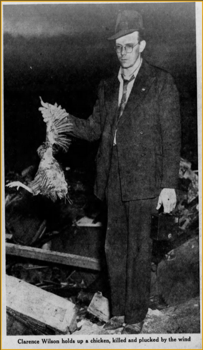 A newspaper clipping with a photo of a man holding a dead chicken among rubble
