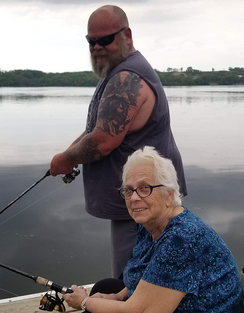 mother and son fishing on a dock