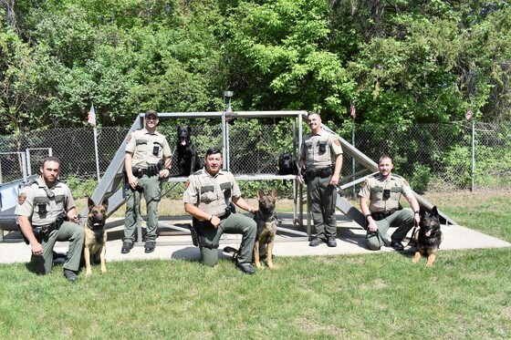 A picture of the five DNR handler and K9 teams