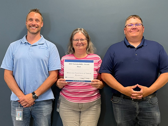 The Fleet team holding the sustainability award